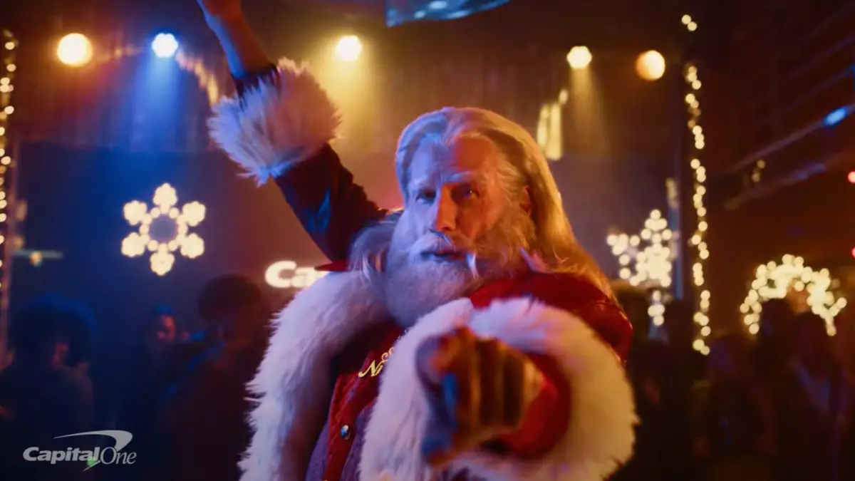 John Travolta is Santa in the 2023 Capital One commercial Auralcrave
